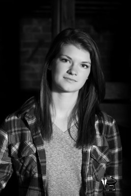 black and white senior pictures in a barn