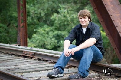 senior pictures on an old fashioned bridge